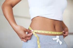 Woman measuring waistline