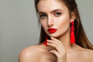 Woman with Red Lips Makeup and Jewelry Earrings